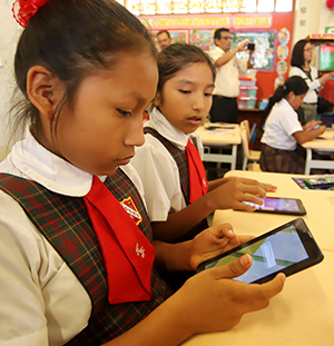 Children at school using smartphones
