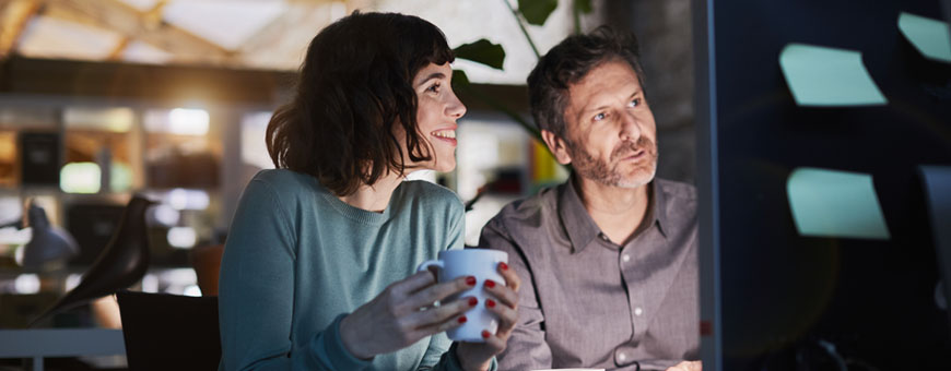 Two people looking at a computer screen