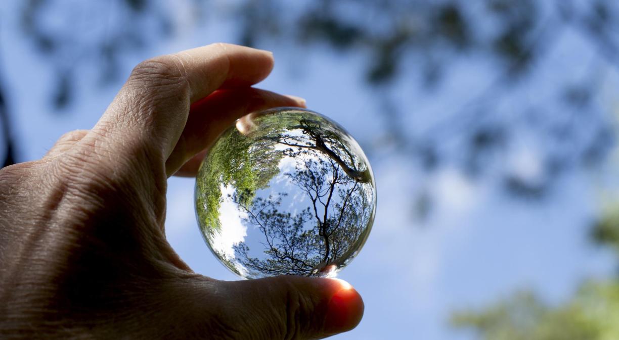 Hand holding a sphere made by crystal