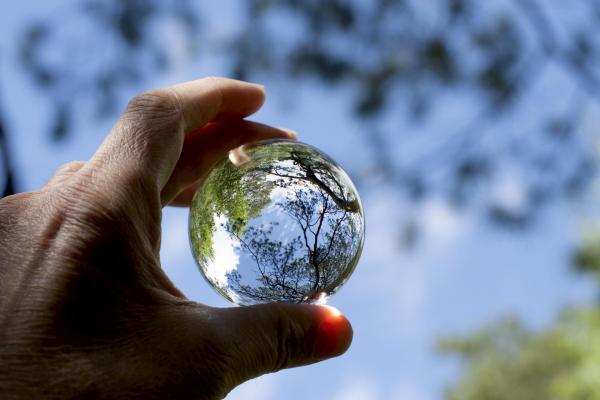 Hand holding a sphere made by crystal