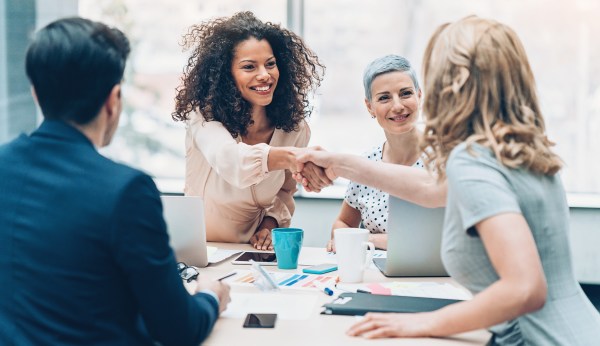 Business persons handshaking on a business meeting