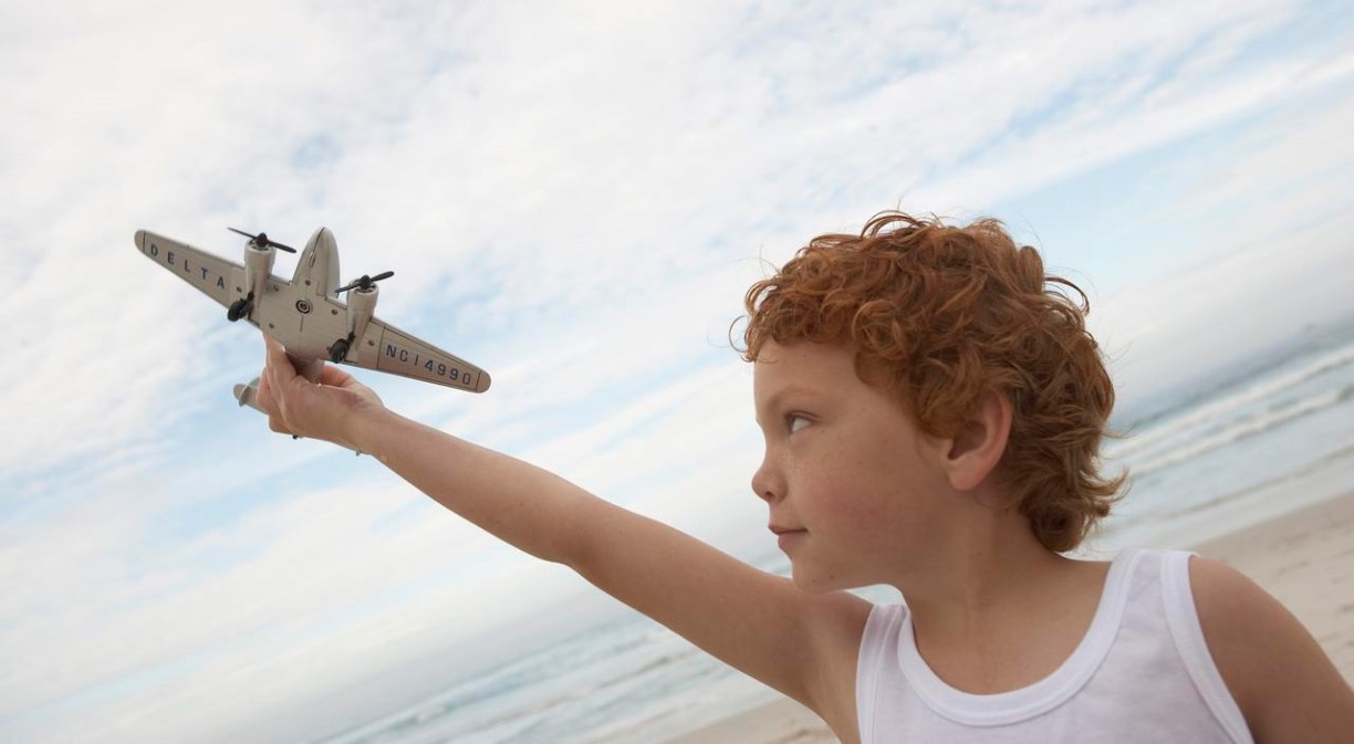 Child playing with an aeroplane