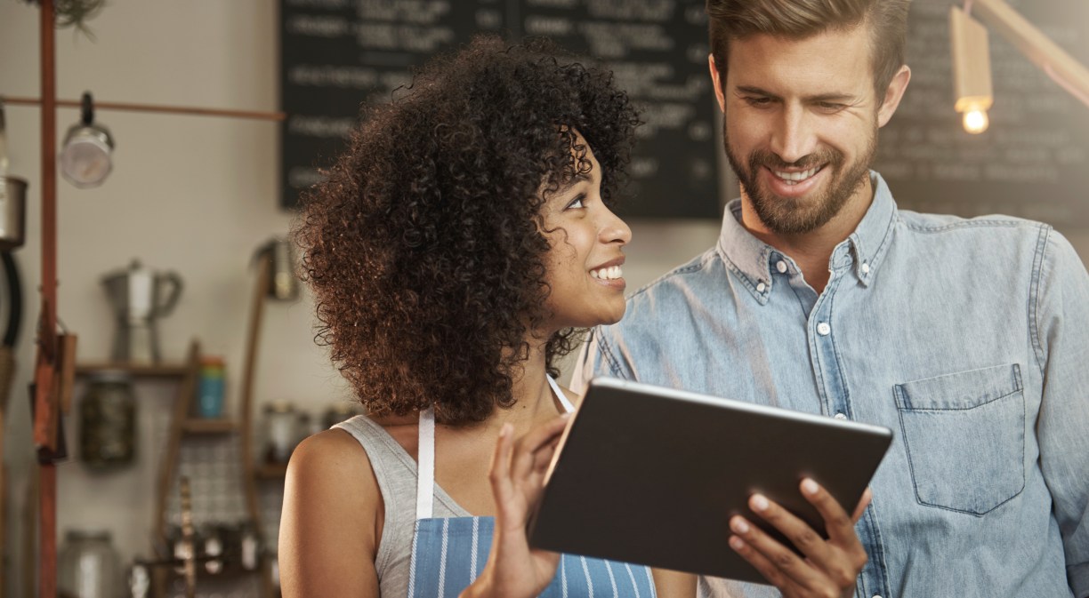 Woman and man looking at a tech device