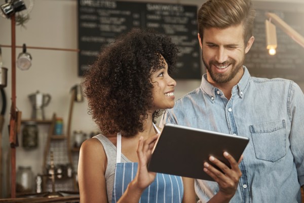 Woman and man looking at a tech device