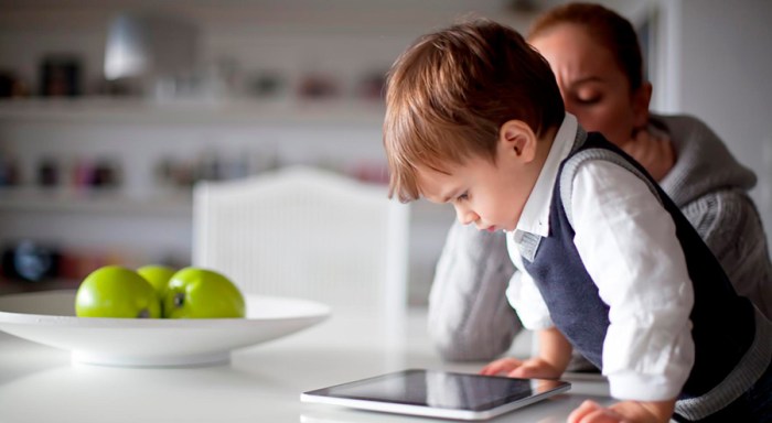 A woman and a child looking at a tablet